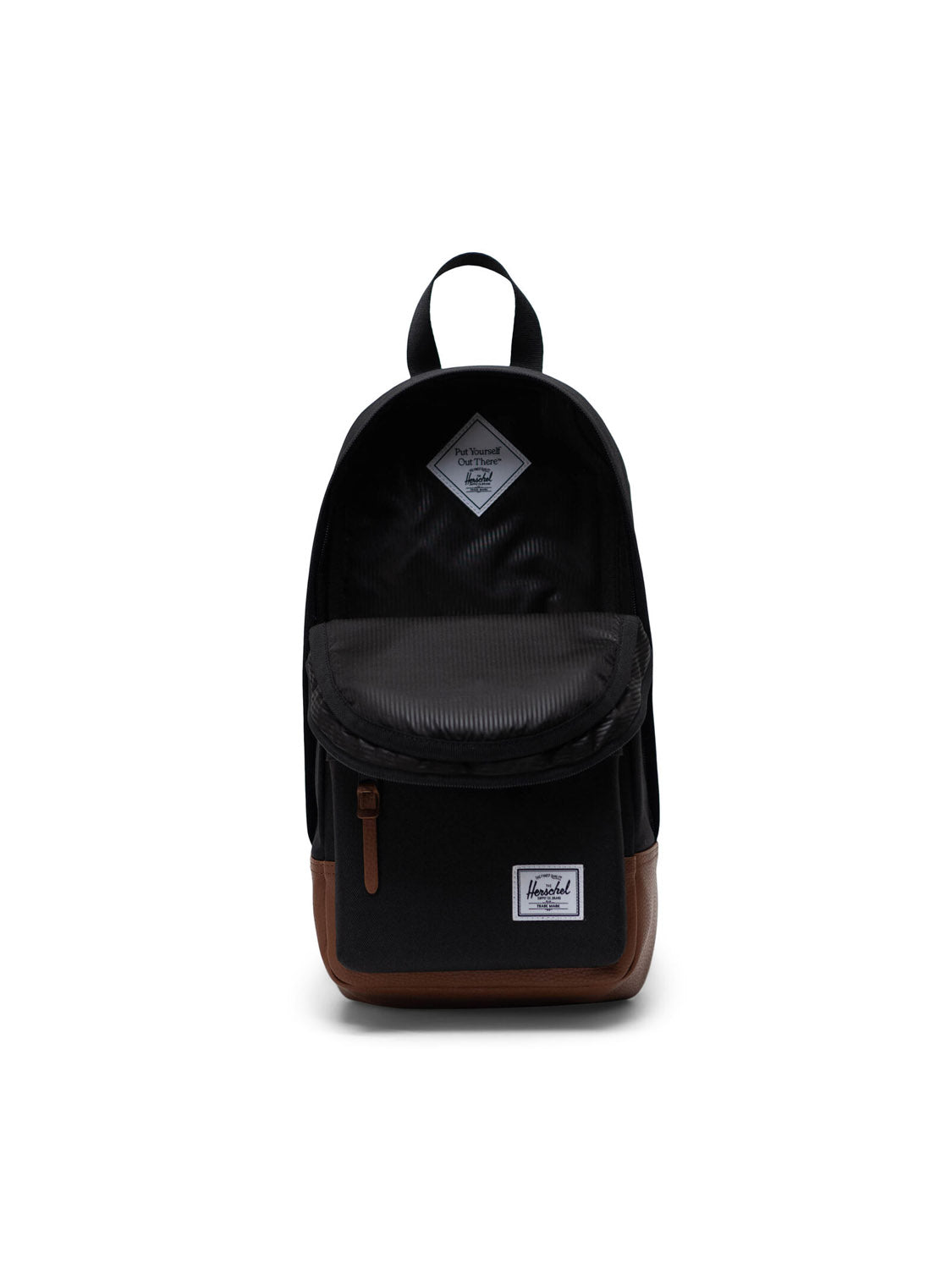 The Herschel Heritage Shoulder Bag features a black exterior, brown leather accents on the base, front zipper pocket, top handle, striped interior in the open main compartment, and a white label on the front pocket.
