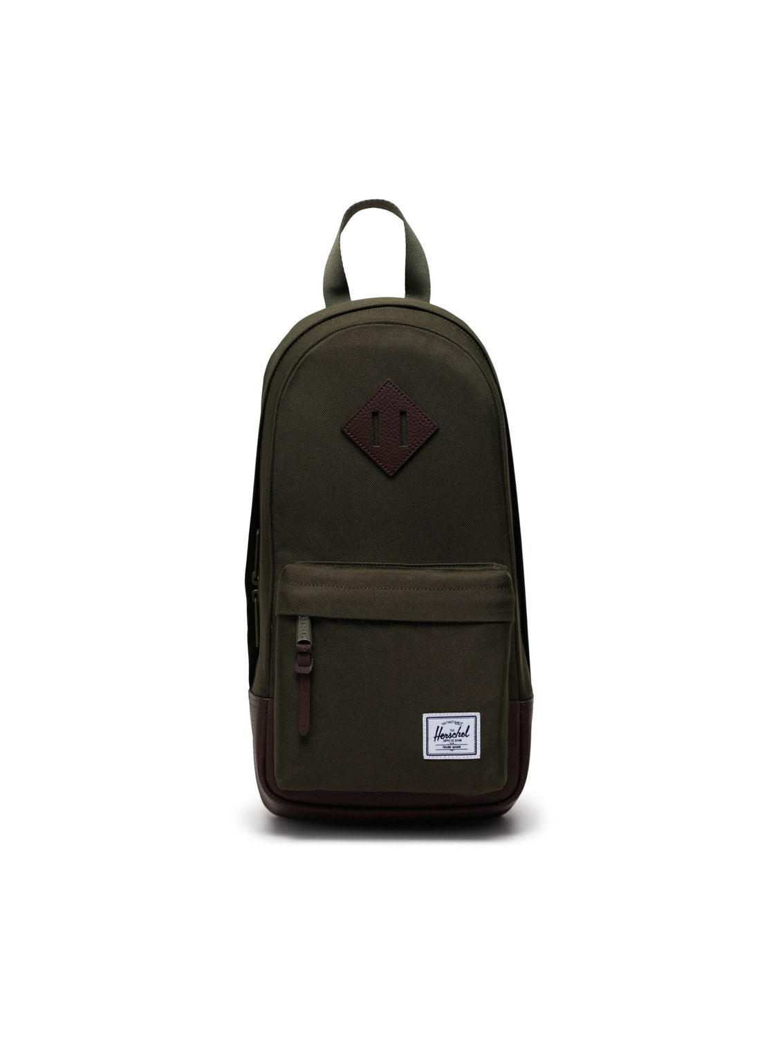 A green and brown Herschel Heritage Shoulder Bag featuring a front zipper pocket, top handle, and a white rectangular Herschel logo patch on the lower front, is shown centered against a plain white background.