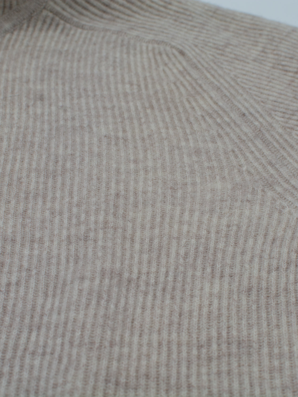 Close-up of the Skien Merino Wool Hoody by ID Menswear in beige, showcasing its soft, ribbed knit texture and vertical lines—an ideal addition to any cold-weather wardrobe.