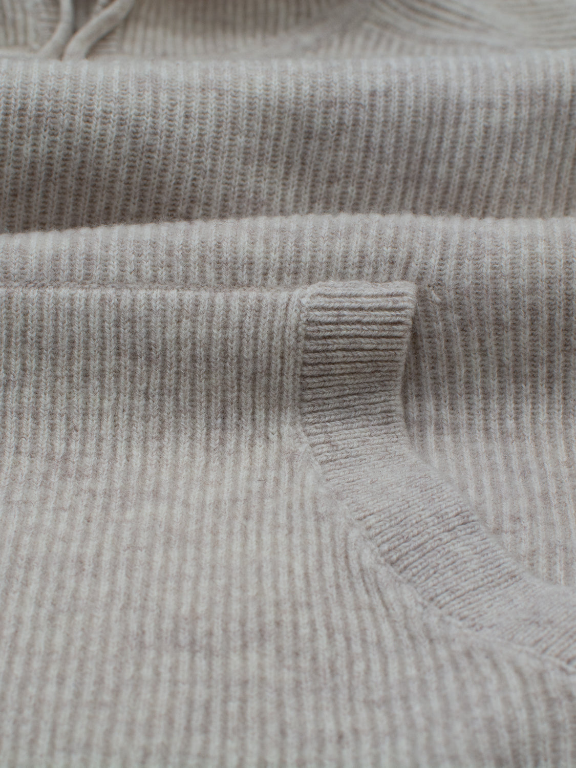 Close-up of the Skien Merino Wool Hoody by ID Menswear in light gray, highlighting its soft texture and subtle horizontal knit—an ideal addition to your cold-weather wardrobe.