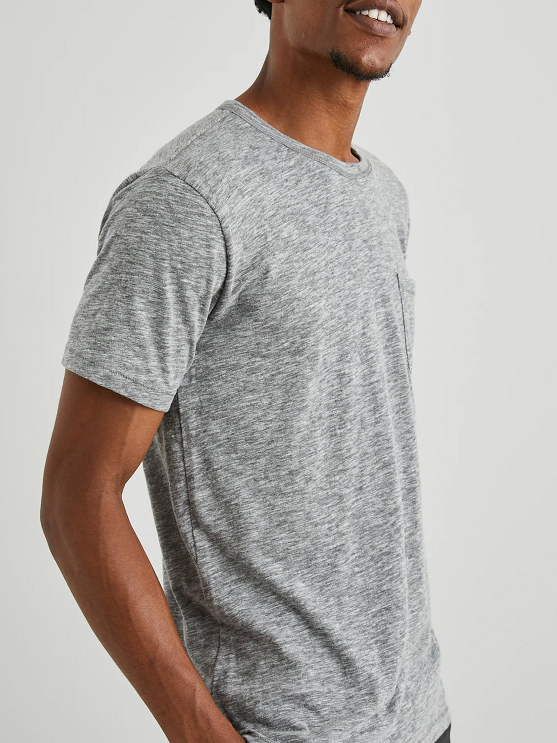 A model wearing the gray Rails Skipper Tee is set against a plain backdrop. The upper body focus highlights the super soft cotton fabric and a small chest pocket, showcasing its casual fit ideal for effortless style.