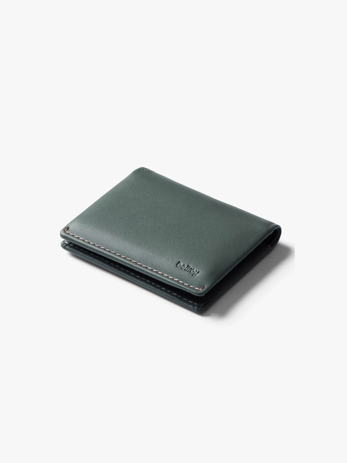 The Bellroy Slim Sleeve Wallet is a closed, minimalist dark green wallet with subtle stitching and a small embossed logo, shown on a plain white background.