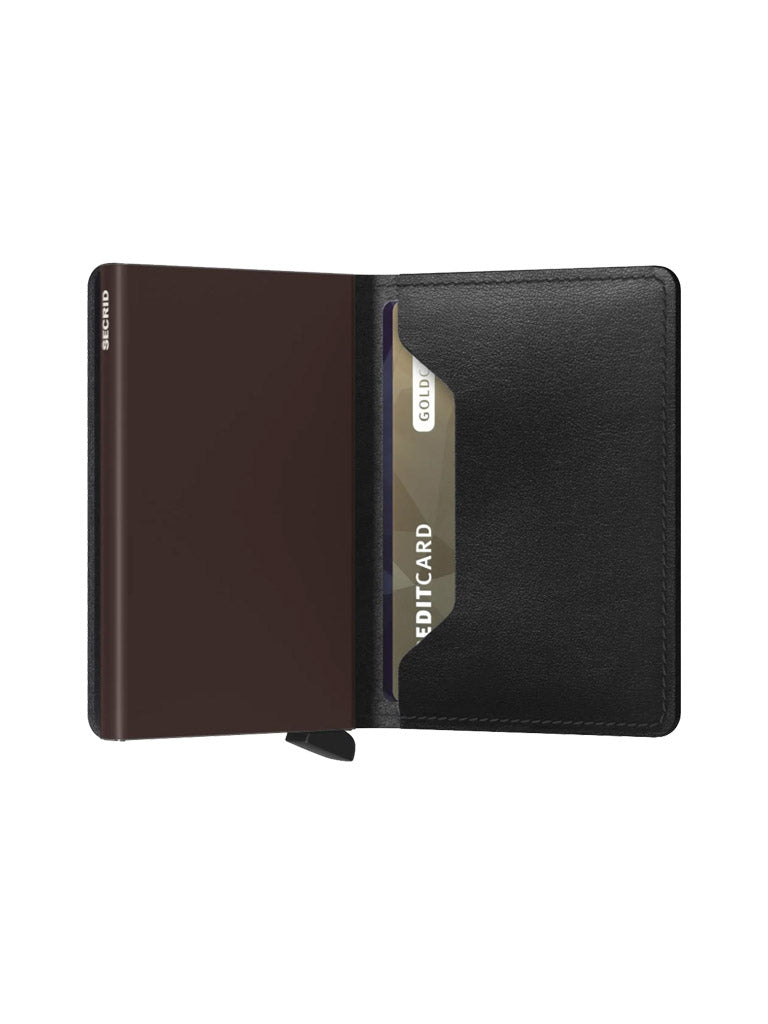 The Secrid Slimwallet Original, crafted from European leather, is open to reveal a card slot holding a CREDITCARD GOLD. Its smooth, minimalist design offers RFID protection and appears empty except for the card.