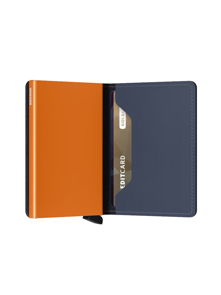 An open Secrid Slimwallet Matte Finished Leather features an orange left panel and dark gray right panel, with a partially inserted credit card in the right slot. This RFID wallet is displayed against a plain white background.