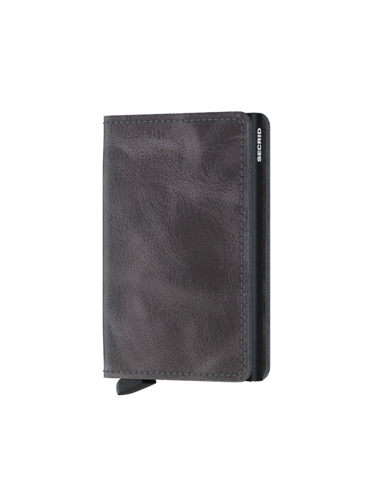 The Secrid Slimwallet Vintage Leather is a dark gray wallet with a textured finish, RFID protection, a small black tab at the bottom, and Secrid printed in white on the edge.