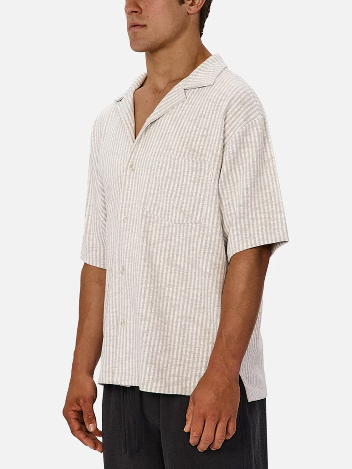 A man wearing the Industrie Sonora Short Sleeve Shirt, featuring breathable cotton and vertical stripes, stands against a plain white background.