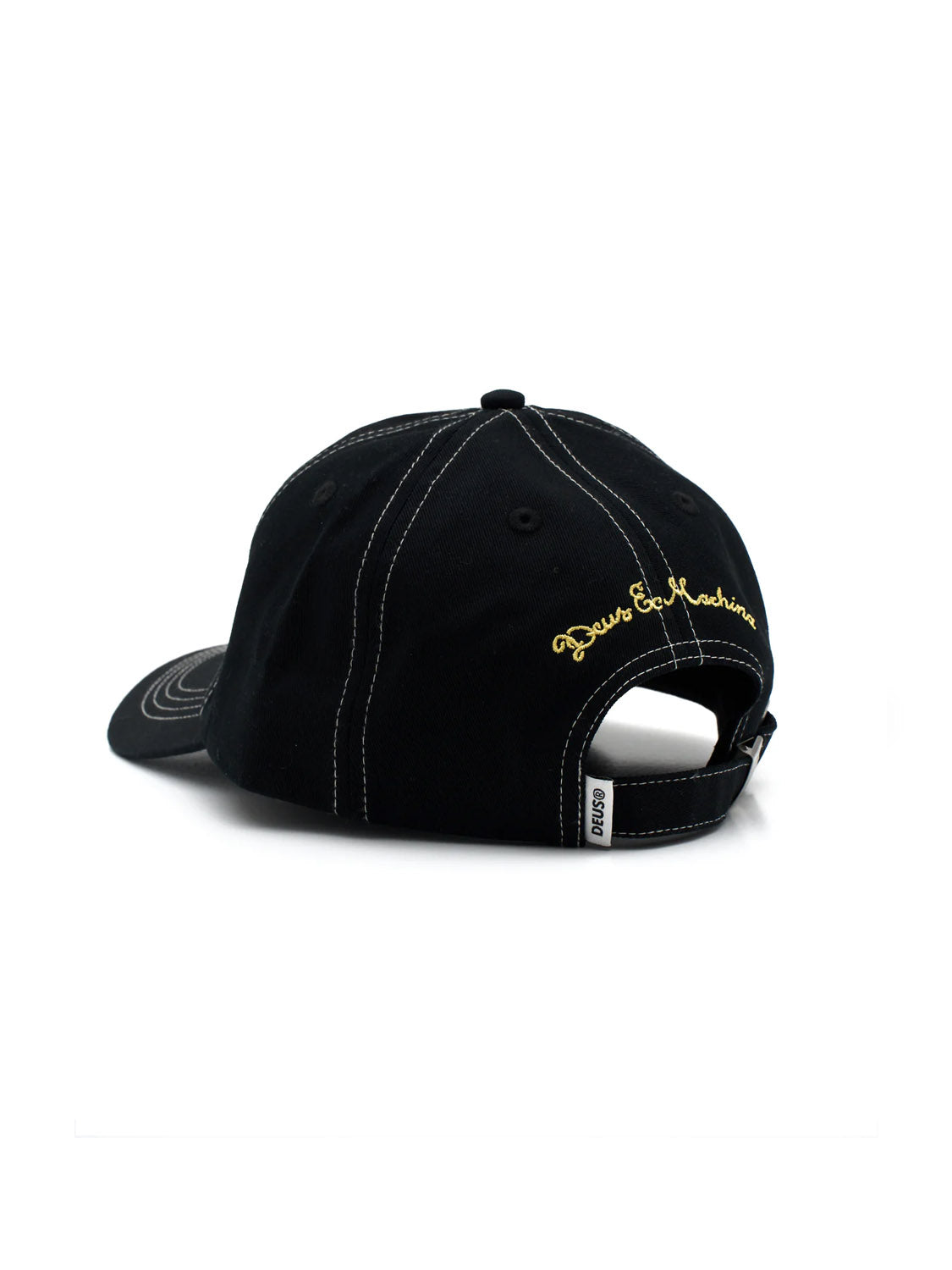 The Speedshop Cap by Deus is shown from the back, featuring black cotton twill, white stitching, a yellow embroidered Deus logo above the strapback closure, and a small white tag on the strap’s side.