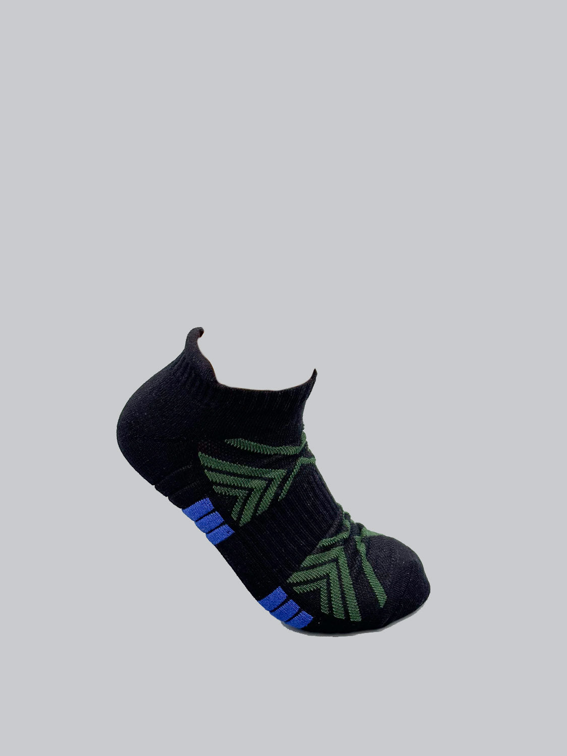 A black ankle-length sock by ID Menswear features breathable, stretchy fabric with green geometric patterns and blue accents on a light gray background.