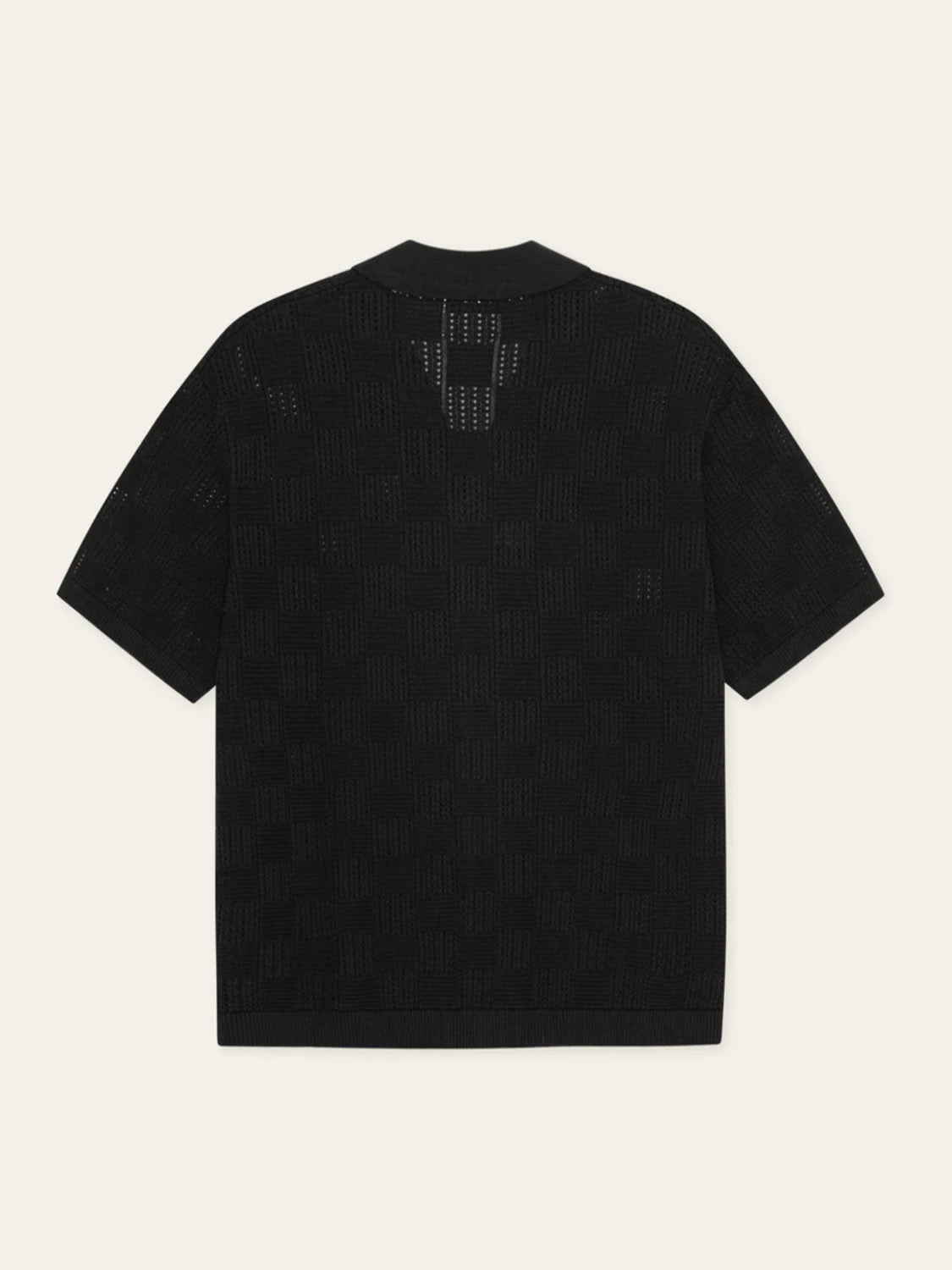 The Les Deux Squared Knitted SS Shirt is a black cotton shirt with a subtle checkerboard texture and camp collar, shown laid flat with the back facing up against a light backdrop.