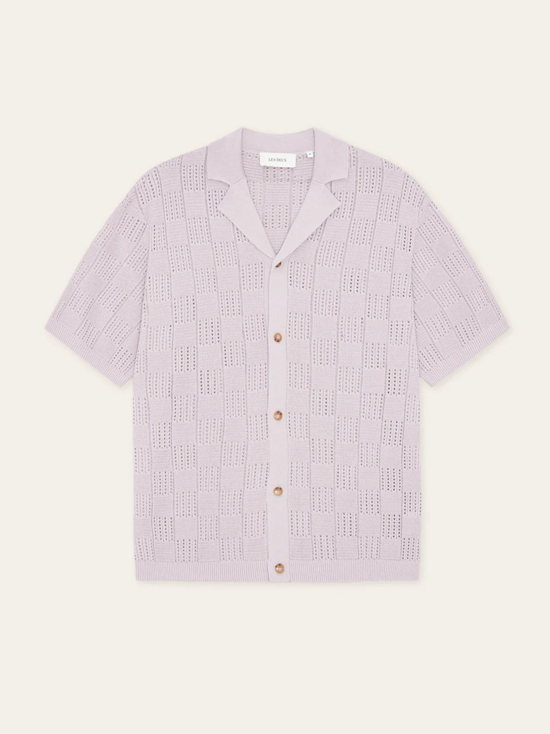 The Les Deux Squared Knitted SS Shirt features short sleeves, a camp collar, light lavender cotton knit with a textured checkerboard pattern, and five brown front buttons for a relaxed yet stylish look.