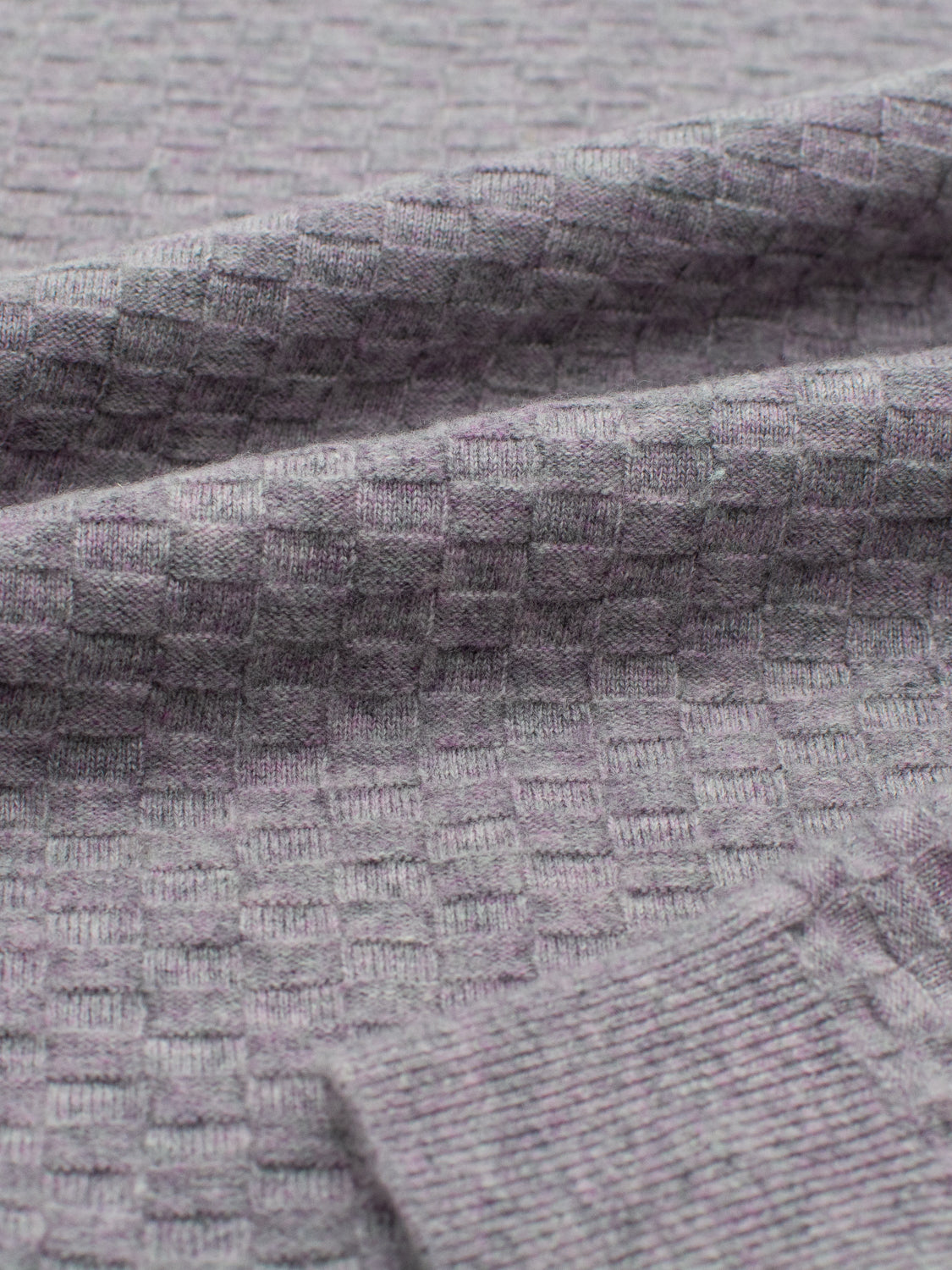 The Stockholm Merino Wool Sweater by ID Menswear showcases a gray checkered pattern. Its soft, basket knit texture radiates warmth and comfort.