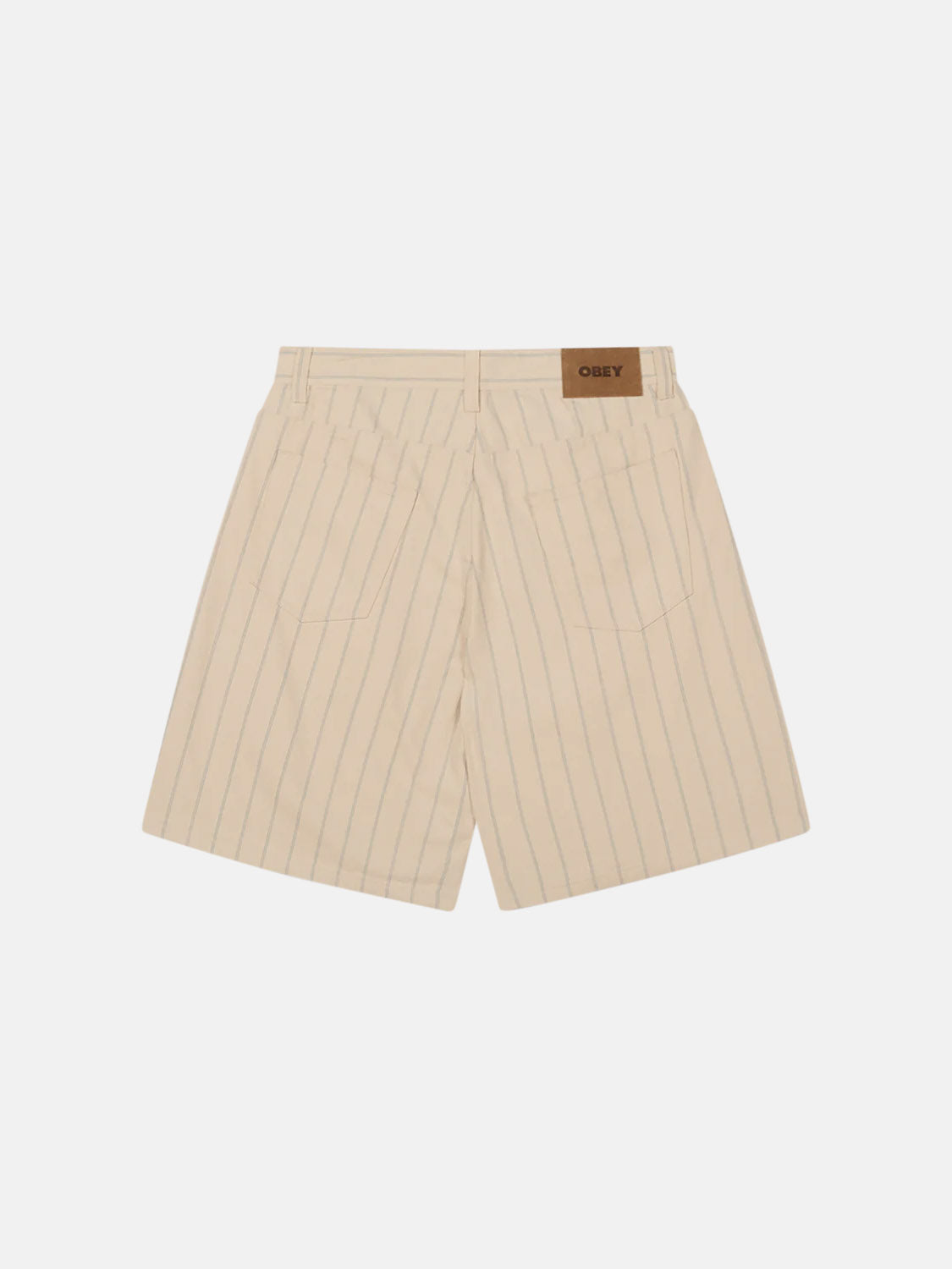 Back view of Obey Stripe Denim Short, a cream-colored, high-waisted design with a baggy fit and vertical pinstripes. Features include two back pockets, a small coin pocket for detail, and a brown Obey label on the waistband.
