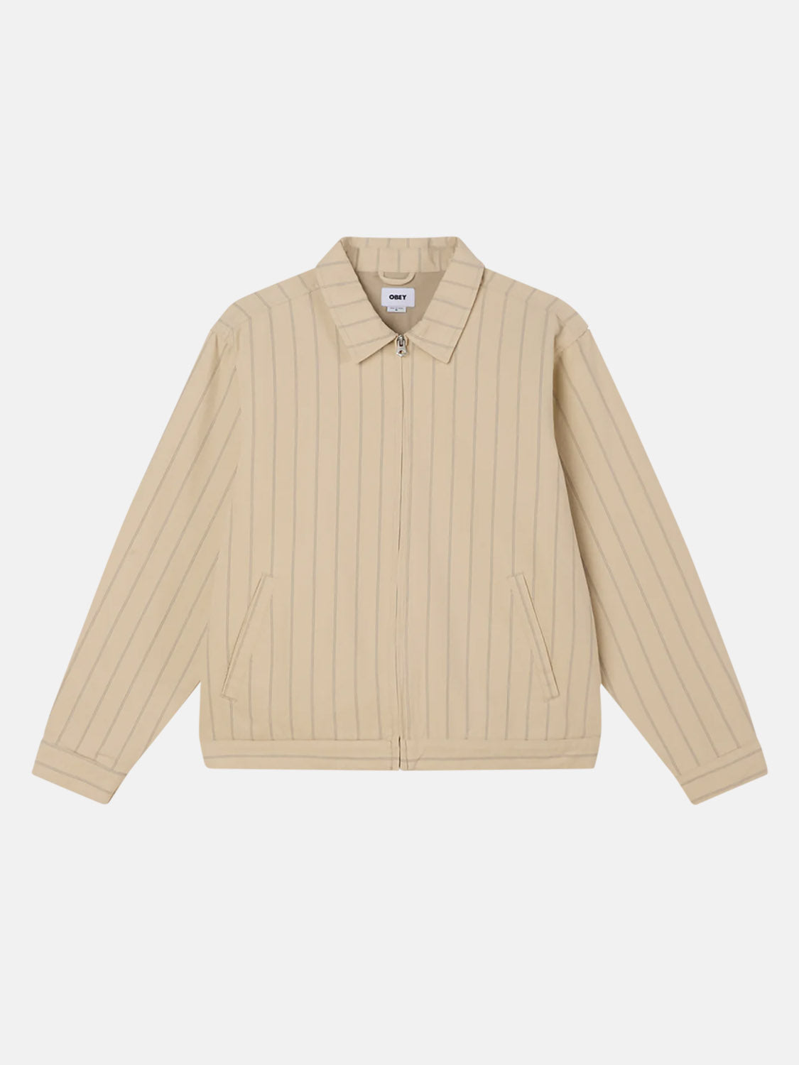 The Obey Stripe Zip Jacket from Obey is a beige zip-up with thin vertical stripes, offering a relaxed fit. It features a collar, two side pockets, long sleeves, and a full zipper closure for easy wear. Laid flat against a white background.