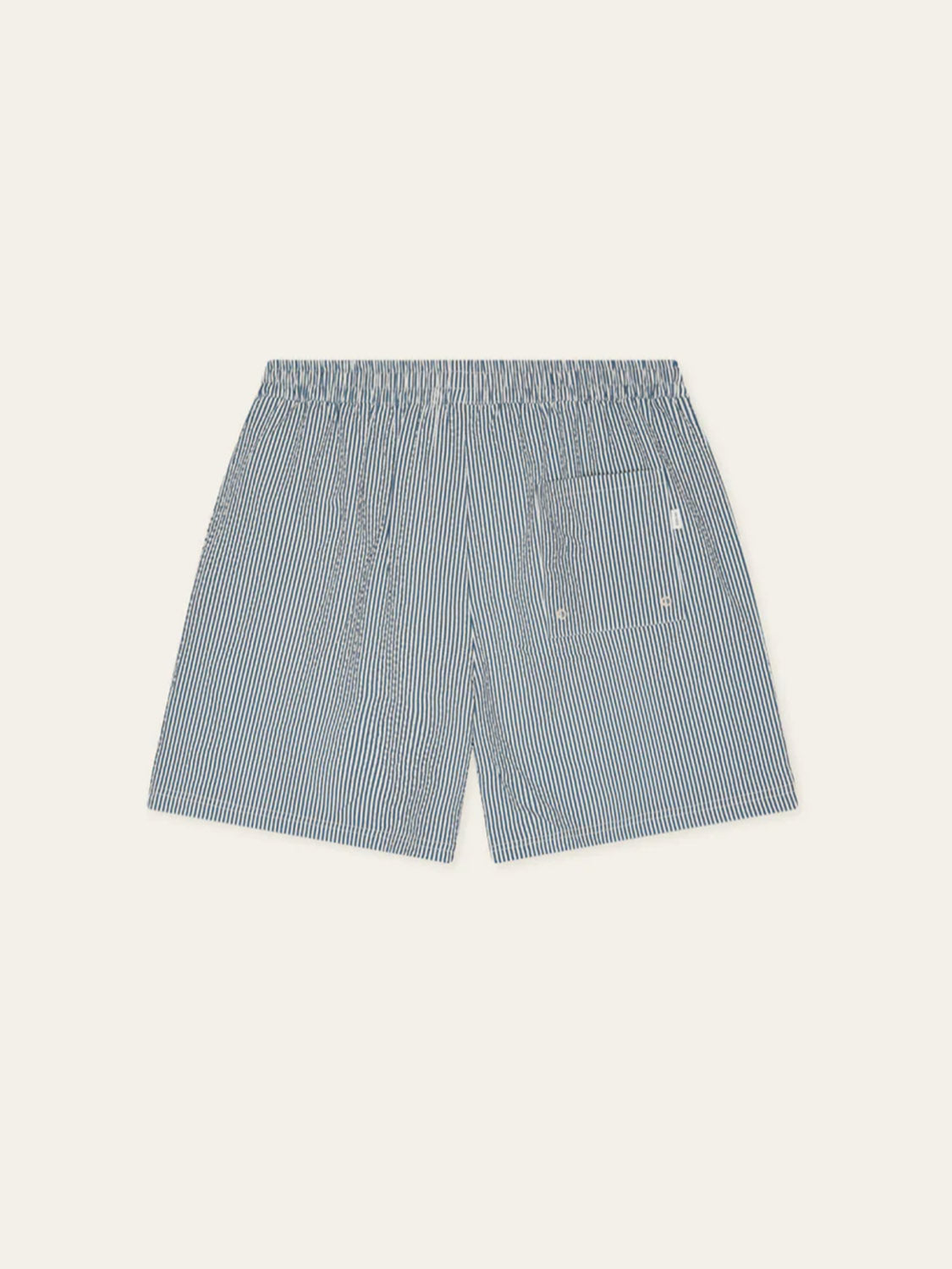 Back view of Les Deux Stripe Seersucker Swim Shorts for men, featuring thin blue and white stripes, an elastic waistband, and a single right patch pocket.