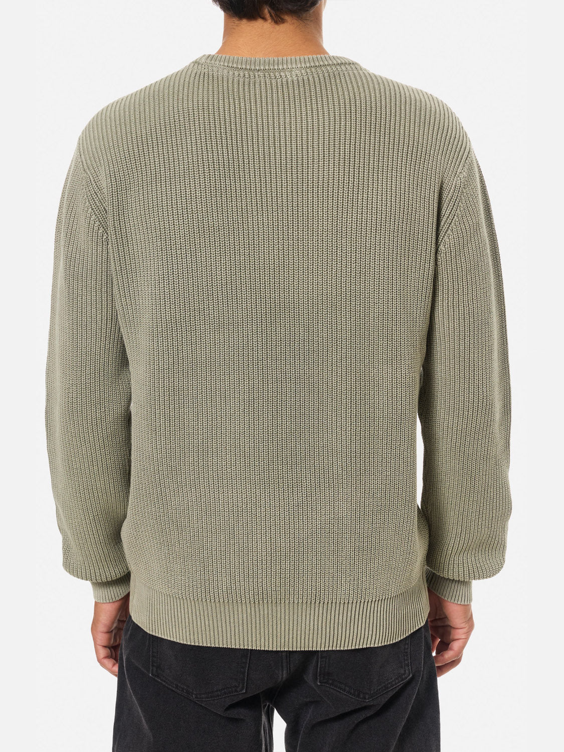 A person is seen from the back wearing the Katin Swell Sweater in light olive green, featuring a vintage wash, relaxed fit, ribbed knit, and long sleeves, paired with black pants.