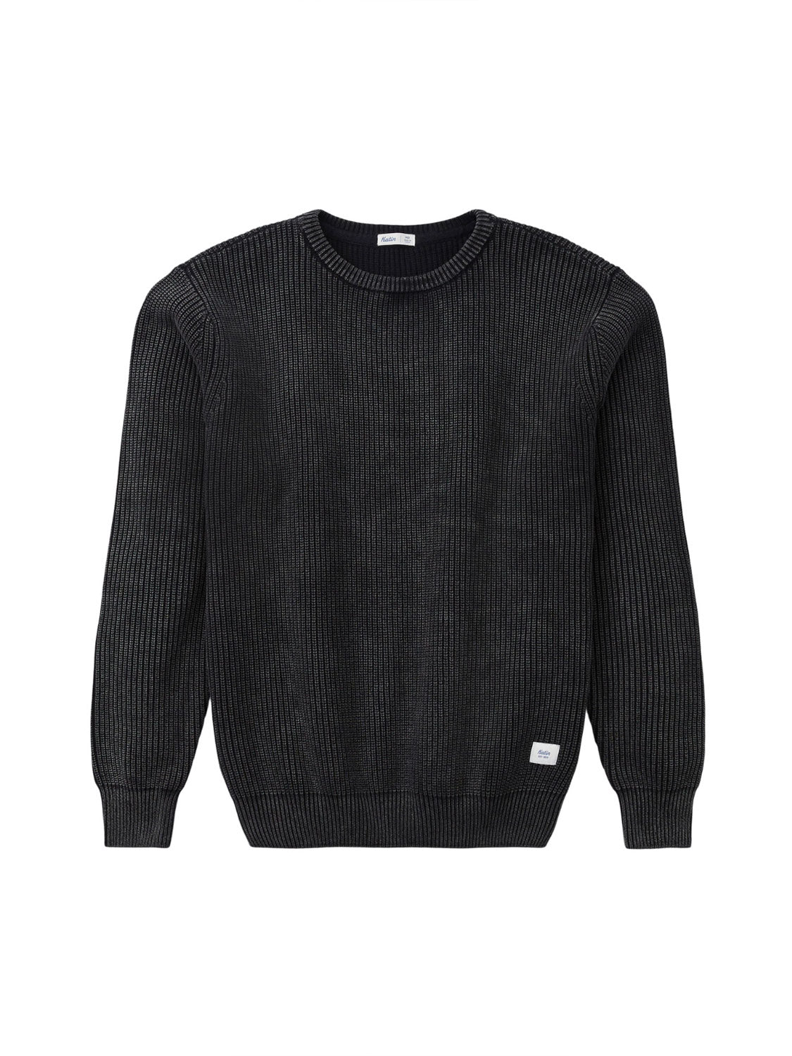The Katin Swell Sweater is a black, long-sleeved, ribbed knit crewneck made from 100% cotton, featuring a small white tag on the lower front hem. Shown against a white background.