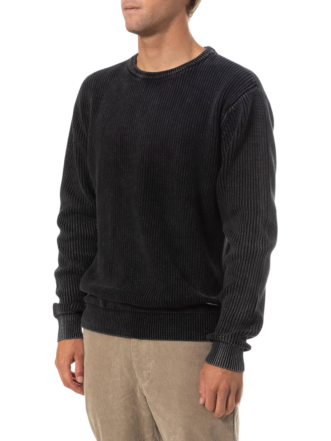 A person wearing the Katin Swell Sweater in a dark vintage wash and light beige corduroy pants stands against a white background, with their head partially out of frame.