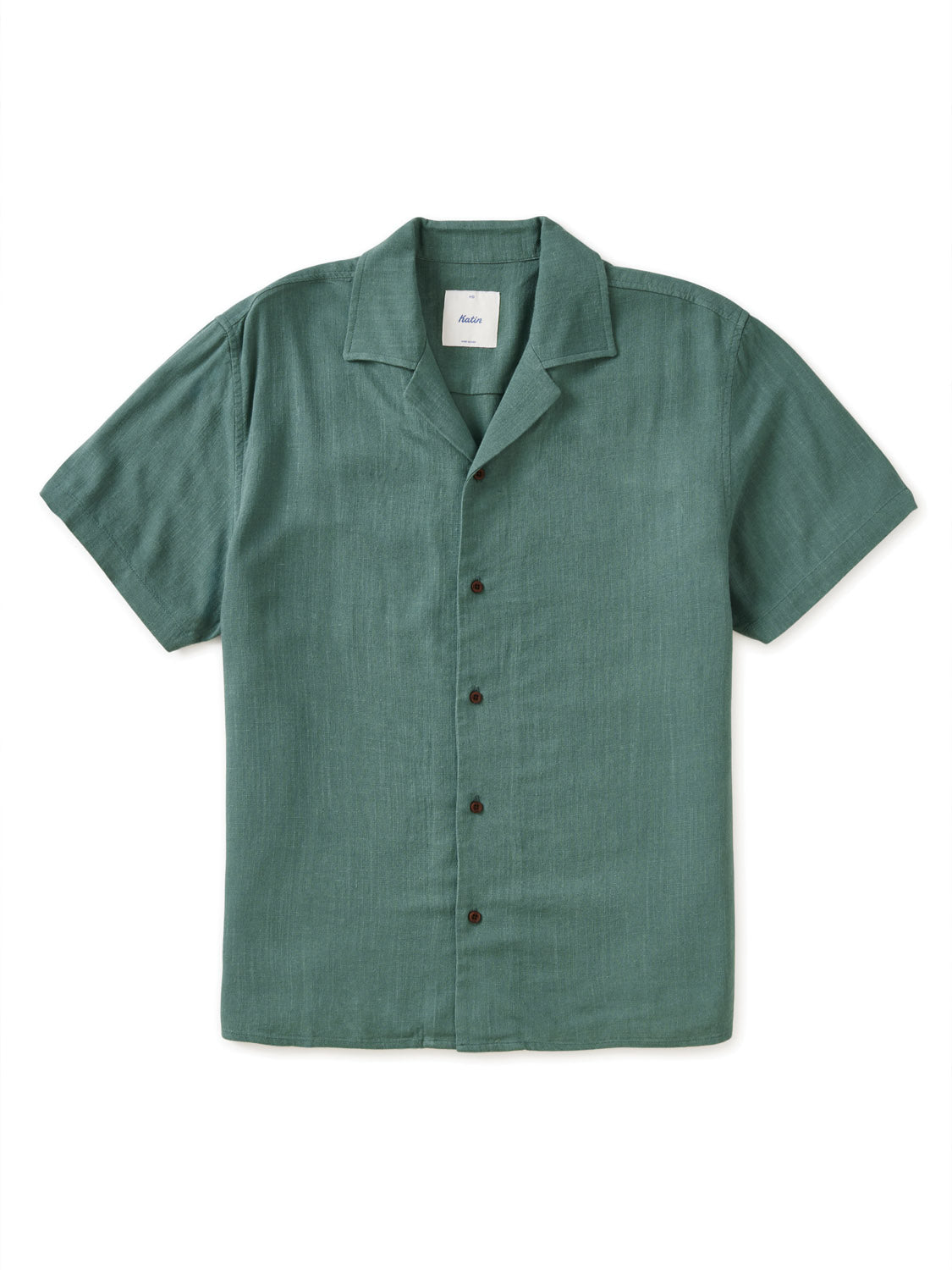 The Katin Teller Shirt is a short-sleeved, button-up shirt in dark green, made from a rayon linen blend. It features a camp collar and dark buttons down the front and is laid flat on a white background.