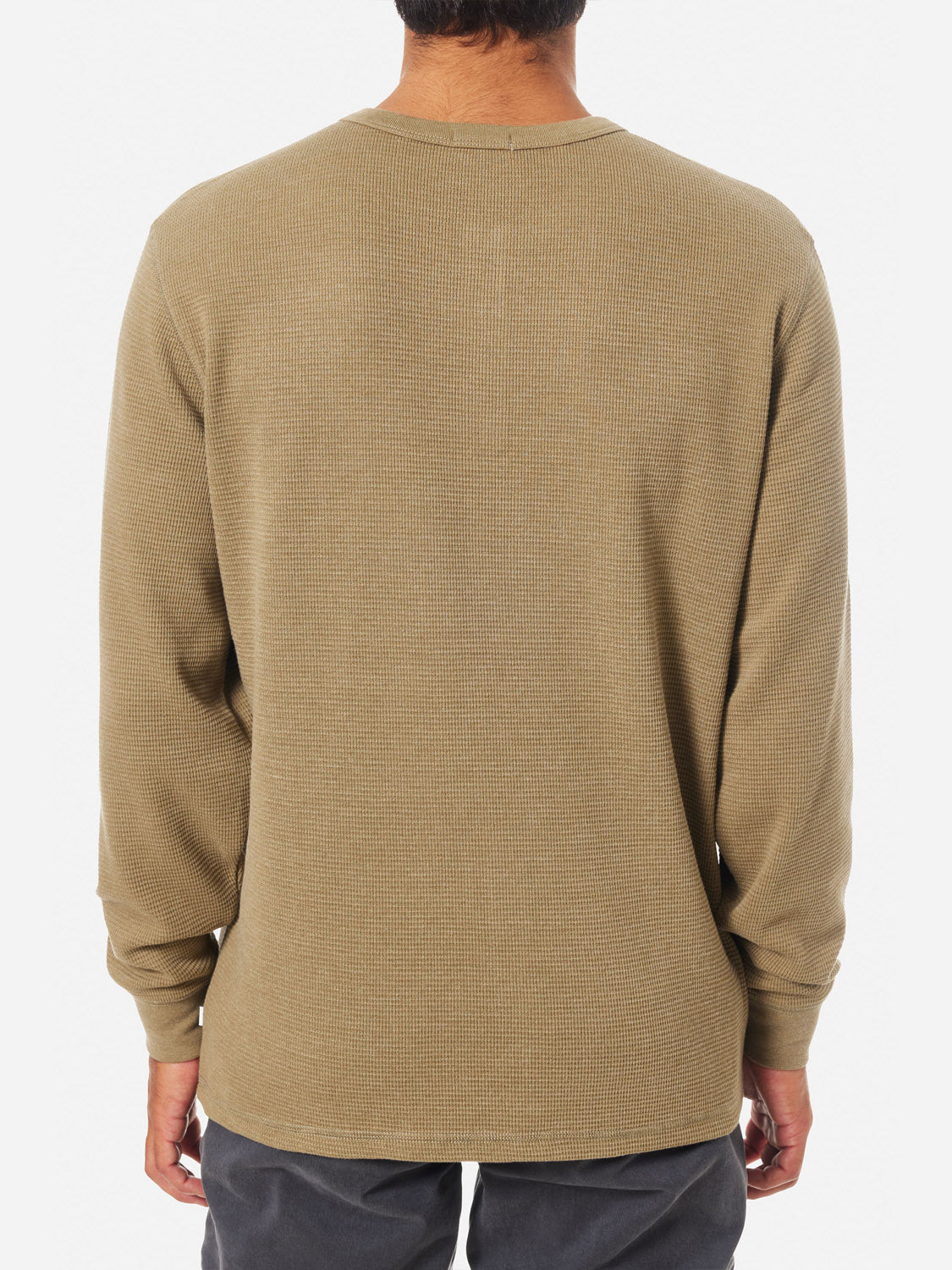 A person is seen from the back wearing a Katin Mesa Thermal, a long-sleeve, olive-colored waffle knit shirt, expertly paired with dark pants.
