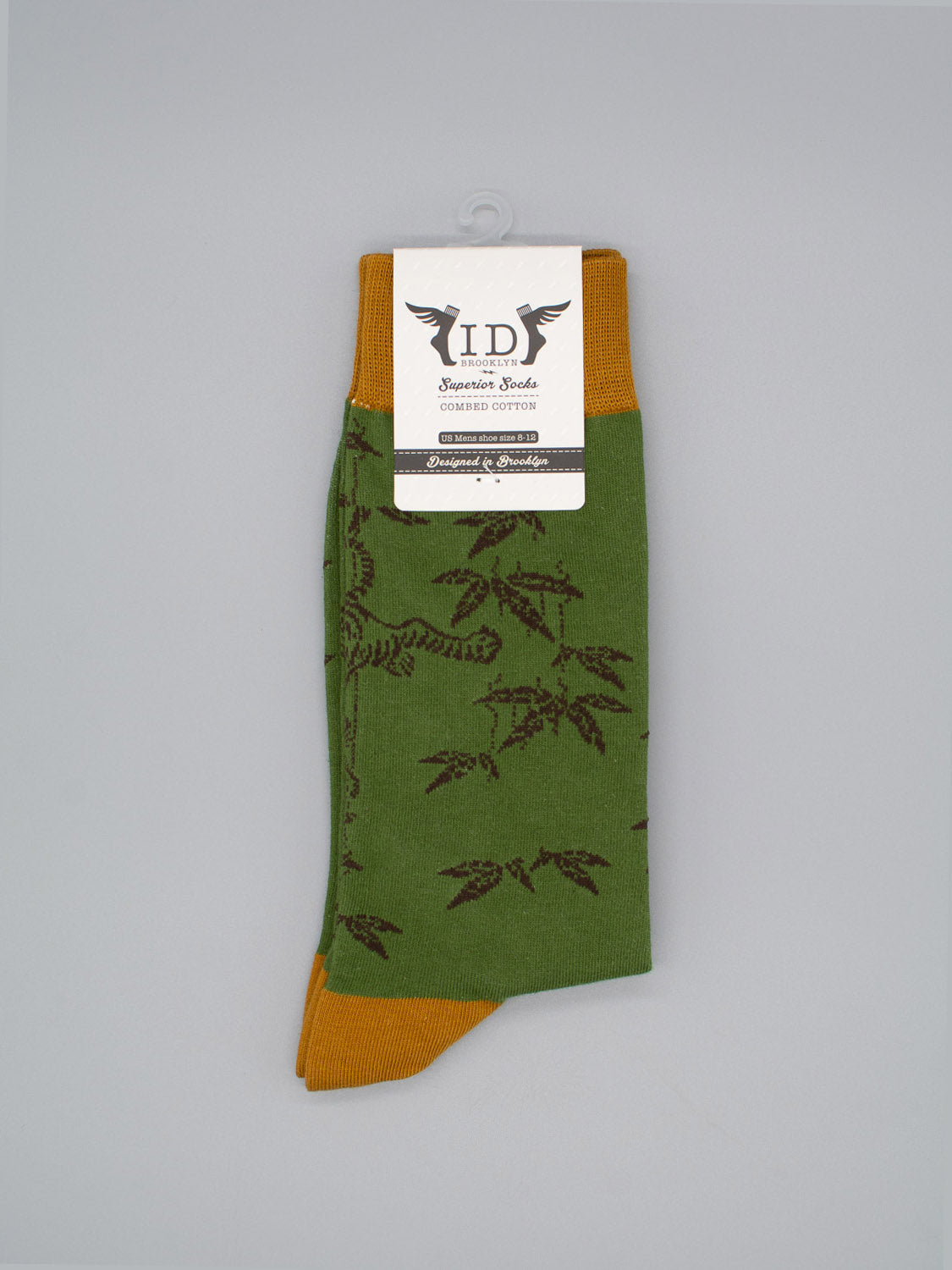 Tiger Graphic Socks by ID Menswear: green socks with brown toe and cuff, featuring a dark brown tiger and foliage pattern in soft combed cotton. Comes with branded tag. Limited edition design.