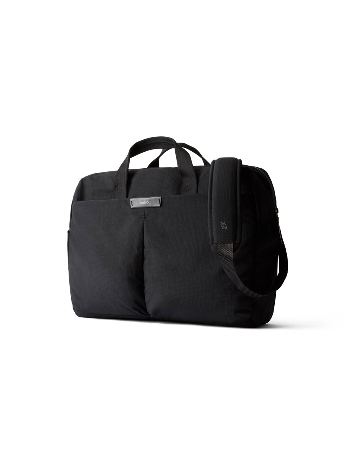 The Bellroy Tokyo Work Bag - 20L is a black professional commuter bag with two top handles, a front pocket, a detachable shoulder strap, and a 16” laptop sleeve, shown on a plain white background.