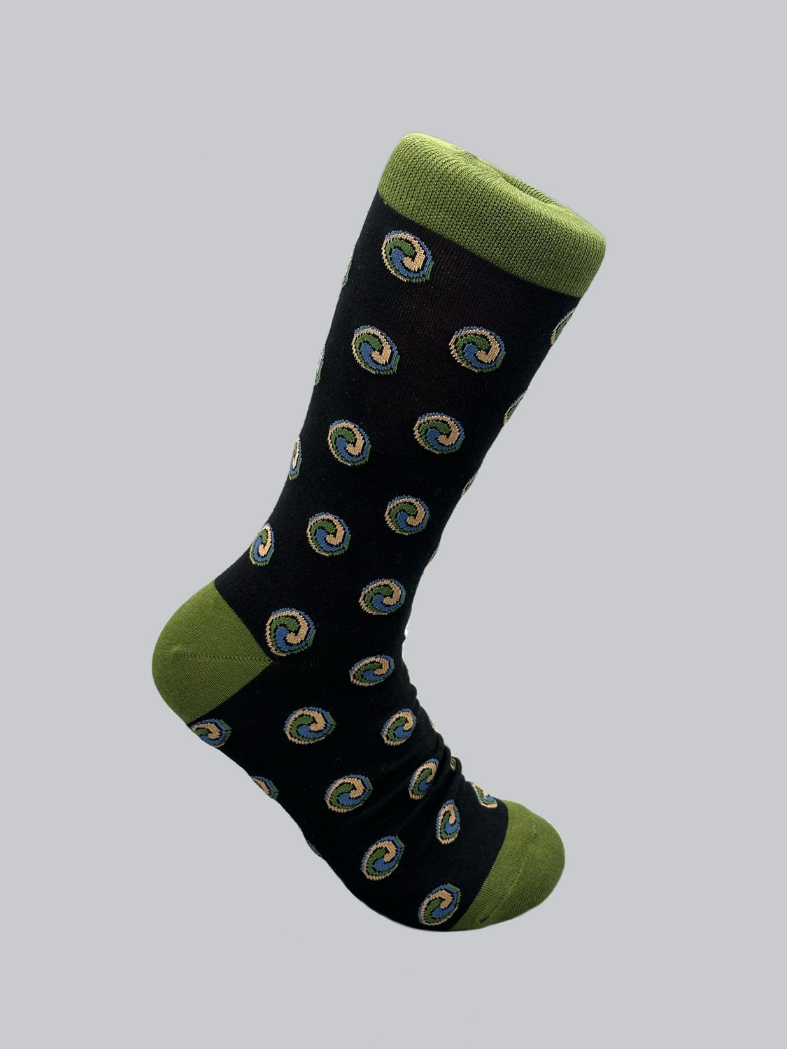 Explore ID Menswears Trinity Graphic Socks, crafted from combed cotton. Featuring a black design with green toe, heel, and cuff, these socks boast multicolored swirl patterns on a light gray background for a blend of comfort and style.