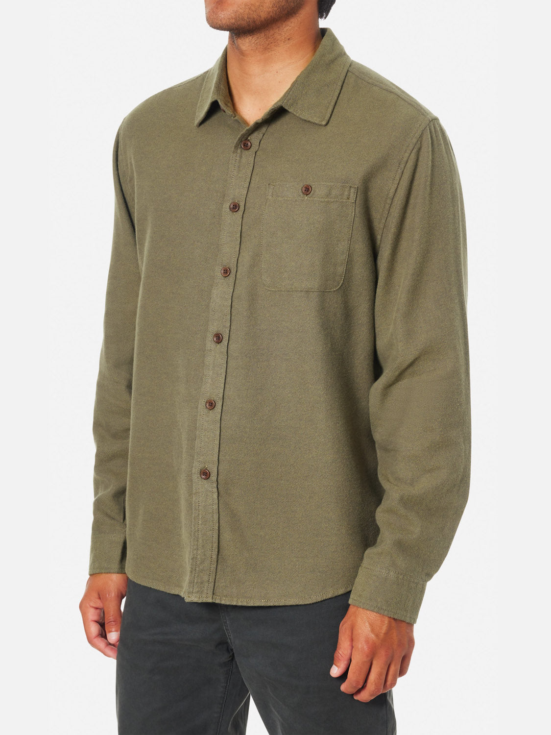 A person wearing the Katin Twiller Flannel Button Down Shirt in olive green with black pants, standing against a plain white background.