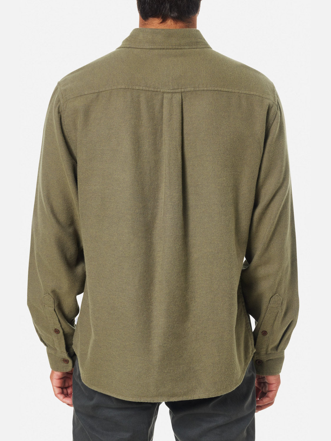 A person is seen from behind wearing a Katin Twiller Flannel Button Down Shirt in olive green with long sleeves and dark pants, standing against a plain white background.