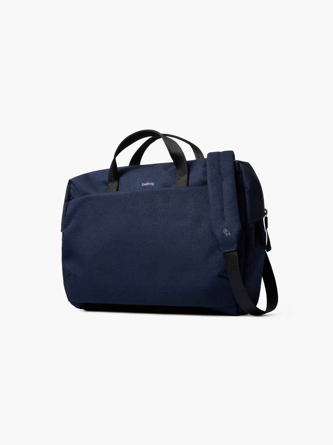 The Bellroy Via Work Bag - 14L, in navy blue with black handles, offers a zippered main compartment, front pocket, detachable shoulder strap, recycled fabric build, and a laptop sleeve—all shown on a plain white background.