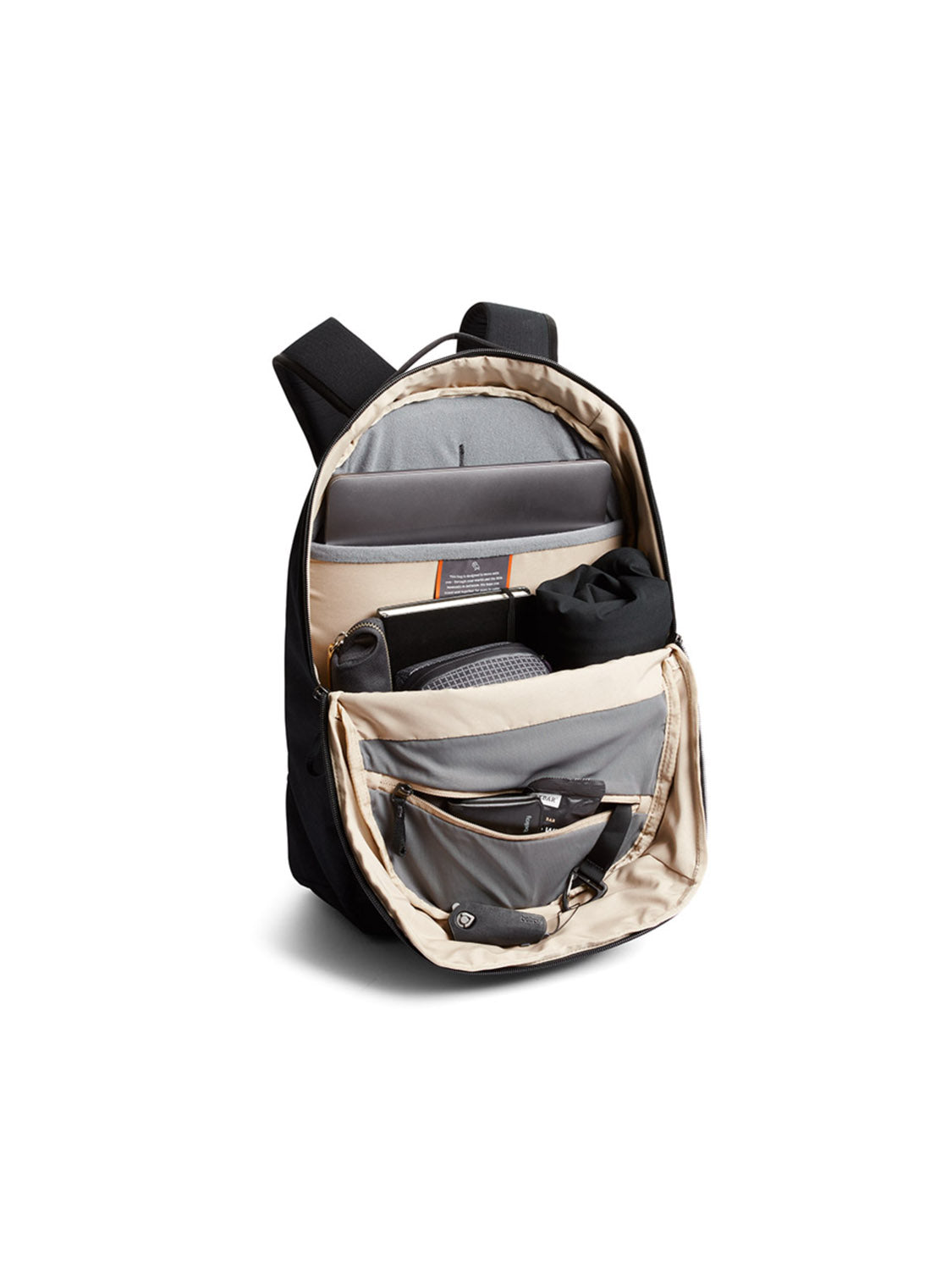 The Bellroy Via Backpack - 20L is shown open against a white background, displaying organized sections with a laptop sleeve, notebook, water bottle holder, and mesh and zippered pockets for small items.