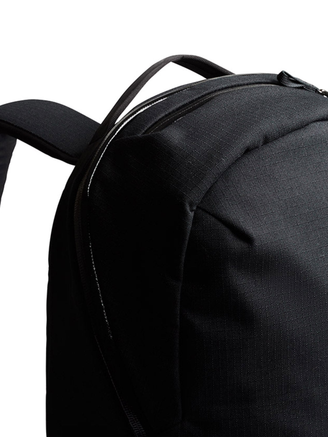 The Bellroy Via Backpack - 20L is a minimalist black backpack with a strap, featuring a laptop sleeve for secure storage.