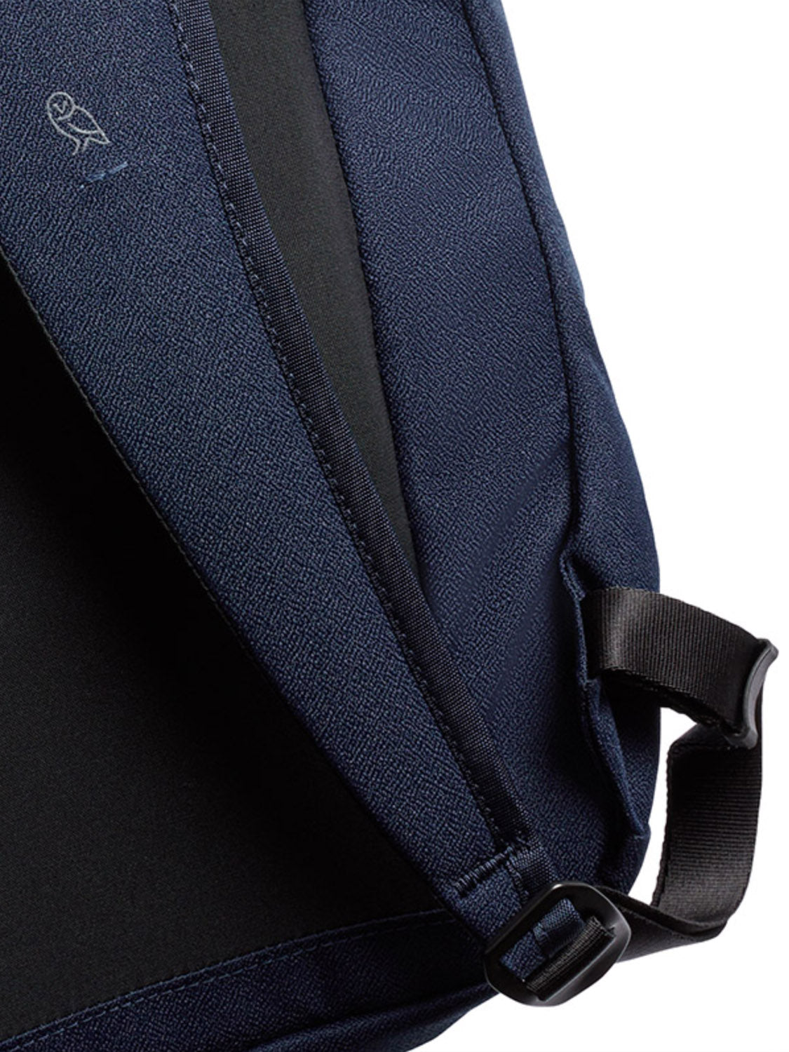 Close-up of the Bellroy Via Backpack - 20L’s navy recycled fabric strap, featuring a black adjustable buckle and a small white owl logo.