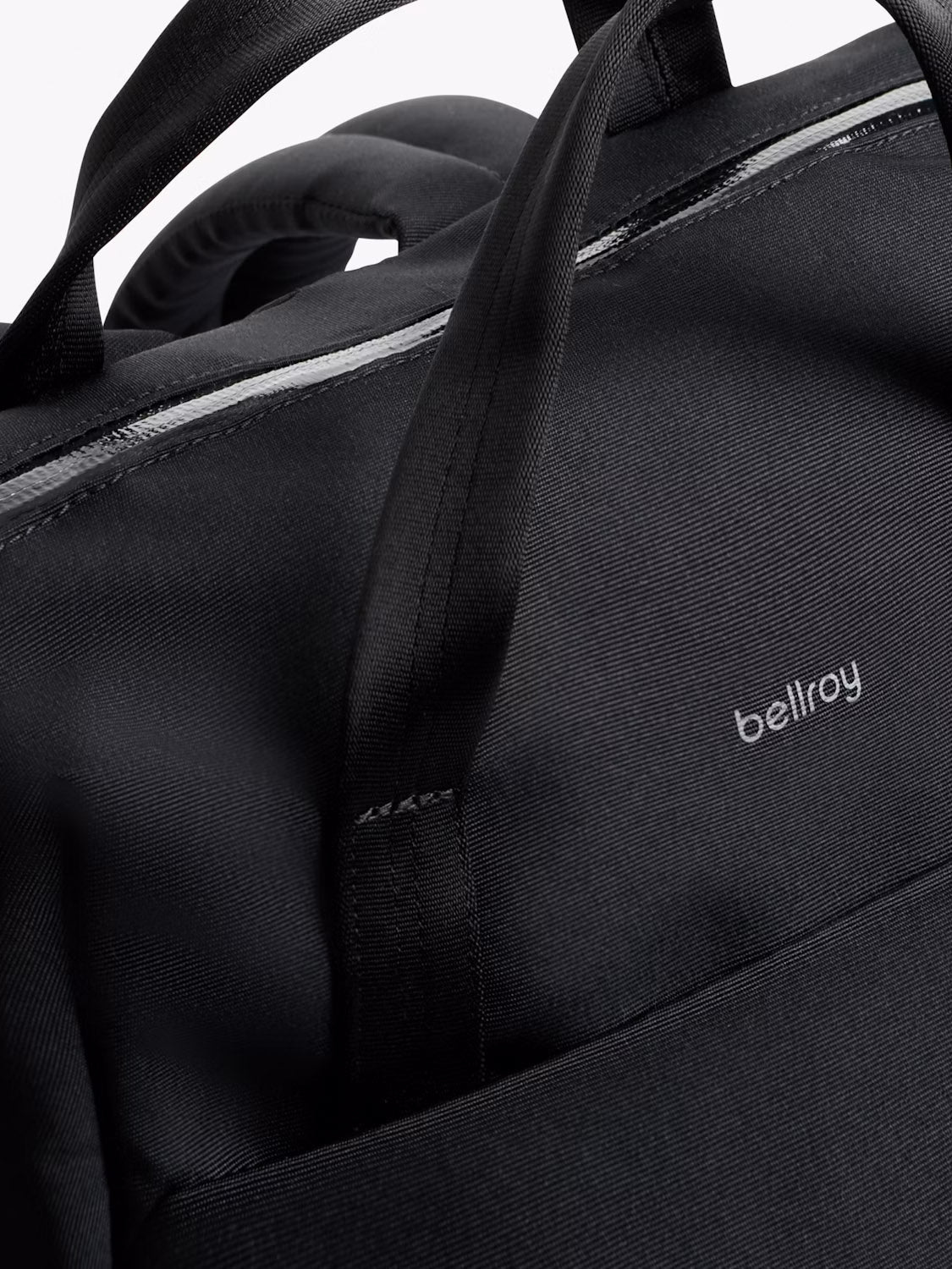 Close-up of the Bellroy Via Workpack - 18L in black, featuring two handles, a zipper, and the Bellroy logo on water-resistant fabric.