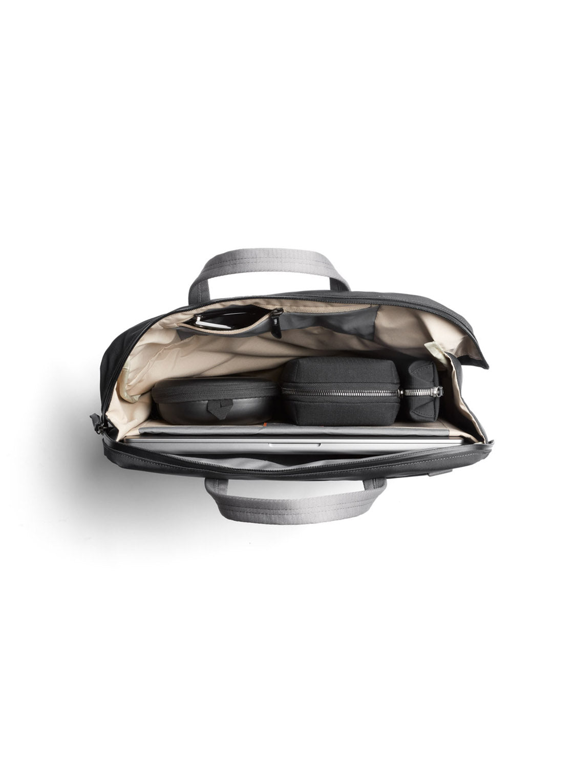 A top-down view of the Bellroy Via Work Bag - 14L in gray with beige lining, made from recycled fabric, neatly organizing a laptop, two zippered cases, sunglasses, and accessories inside.