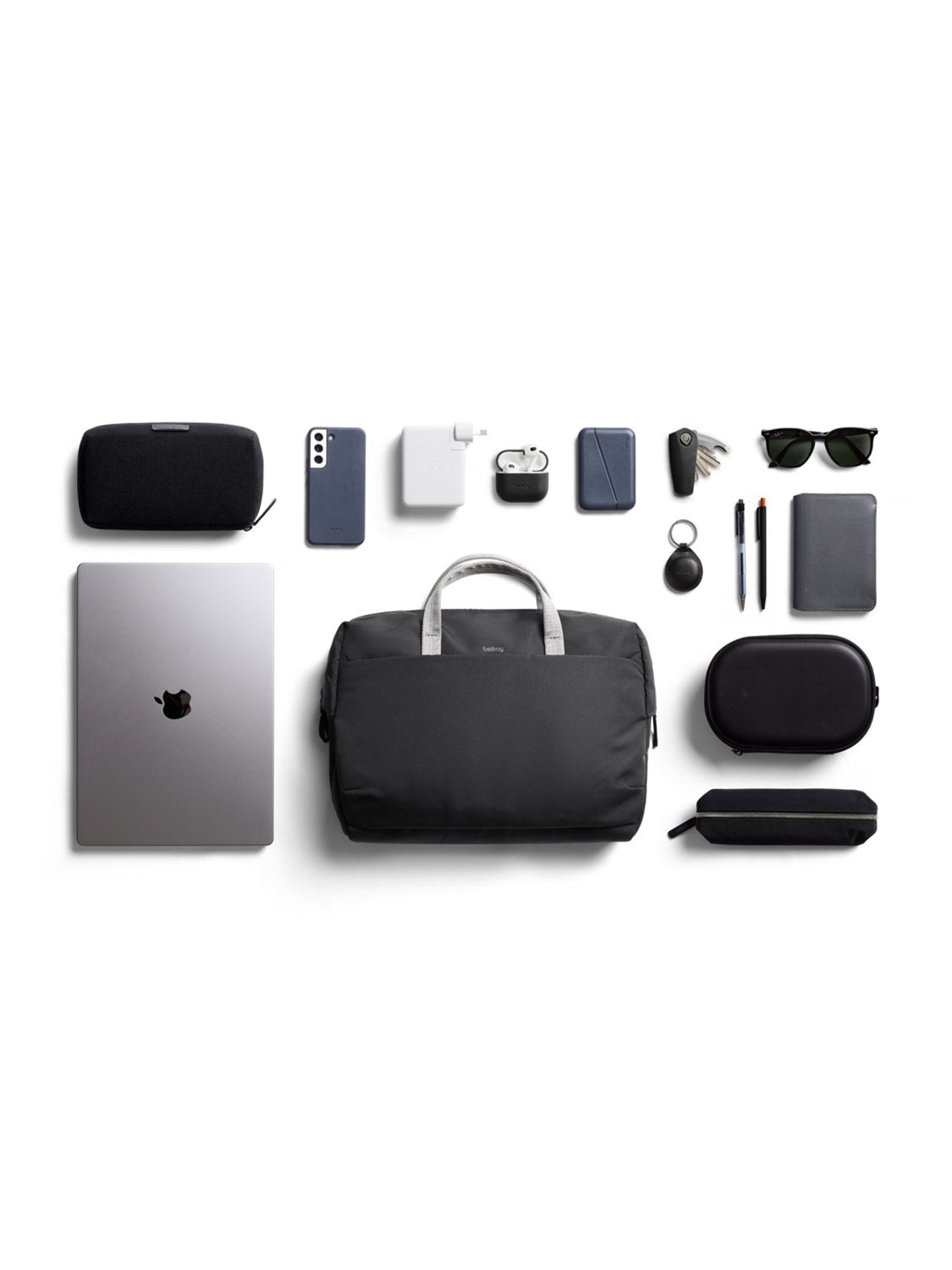 A flat lay of everyday carry items—including a Bellroy Via Work Bag (14L), laptop, phone, sunglasses, wallet, keys, pens, charger, pouch, tech case—neatly arranged on a white background.