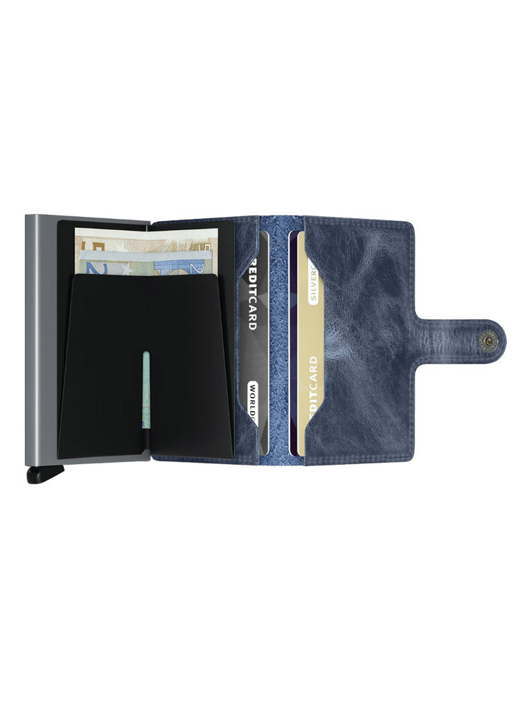 The Secrid Miniwallet Vintage Leather features a snap closure, displays euro banknotes and credit cards, and includes multiple card slots. Its sleek design blends vintage leather with metal accents, offering RFID security for your essentials.