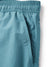 Close-up of the Katin Poolside Volley shorts in teal by Katin, featuring an elastic waistband and a side pocket with visible stitching.