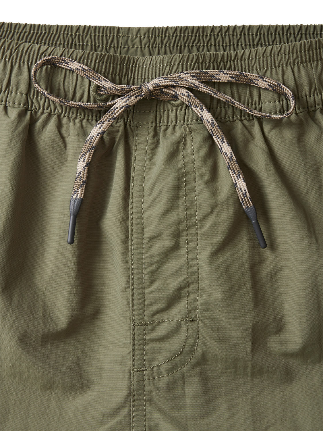 Close-up of Katin Poolside Volley olive green nylon shorts by Katin, with an elastic waistband and beige-black patterned drawstring tied in a front bow. Distinct vertical stitching detail appears below the waistband.