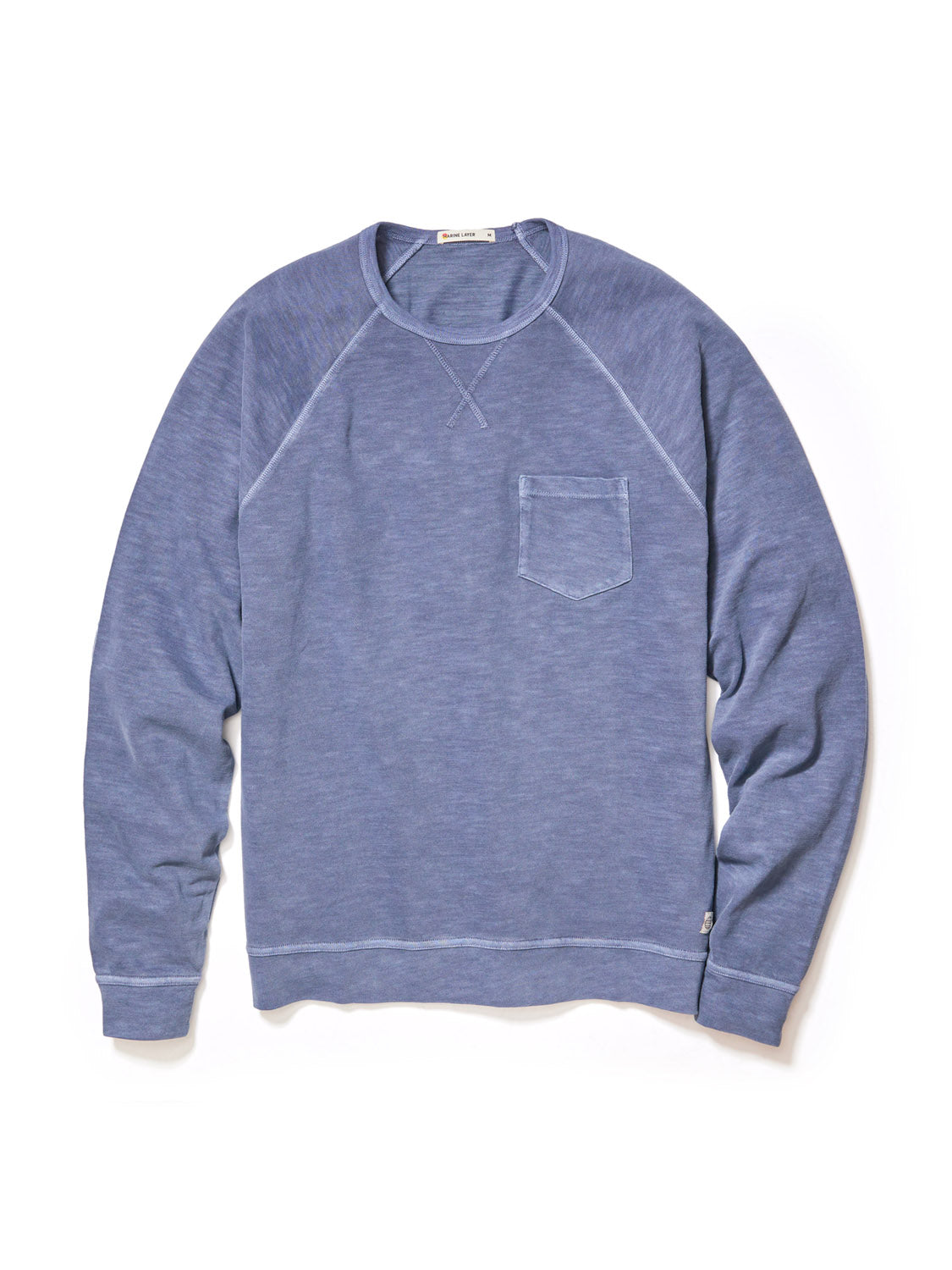 The Marine Layer Vintage Heavy Slub Raglan is a blue long-sleeve crewneck sweatshirt with a chest pocket and raglan sleeves, shown on a white background.