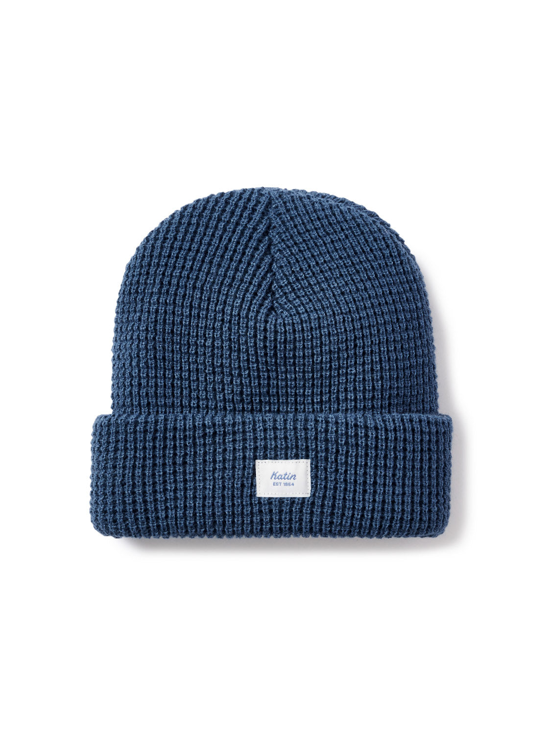 The Katin Wade Beanie is a blue acrylic knit hat with a wide folded brim and a small white rectangular front label—ideal for chilly days.