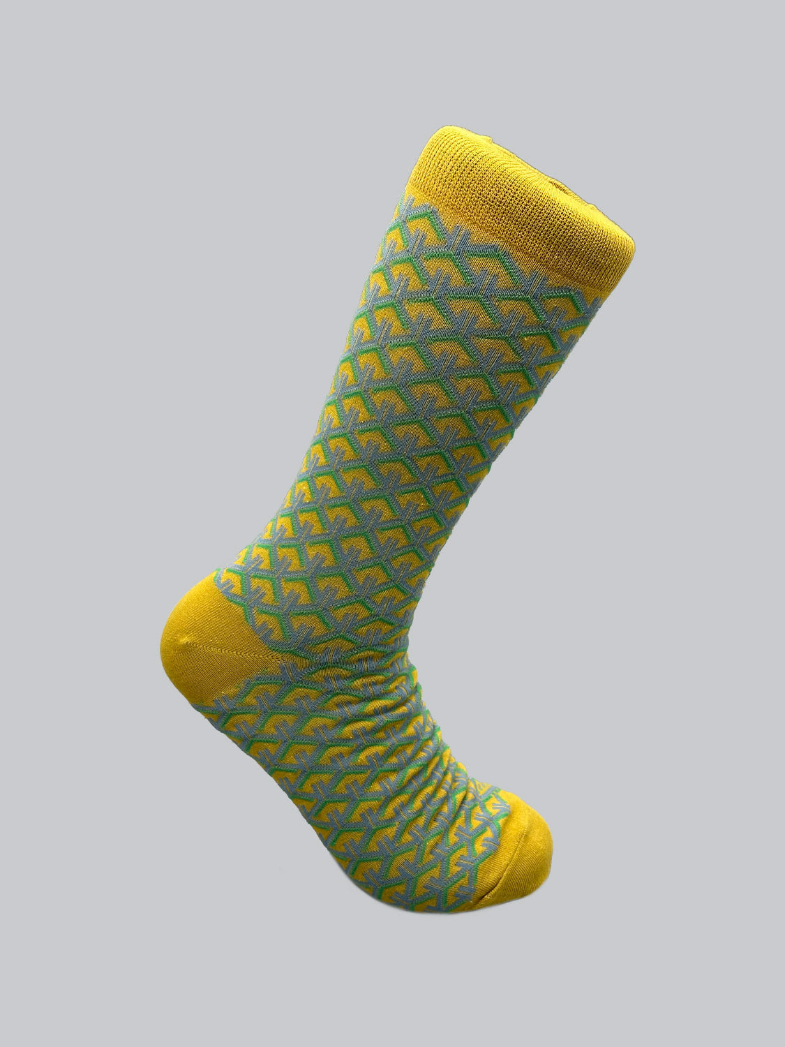 The Wagara Graphic Sock by ID Menswear features a blue geometric Jacquard pattern of connected hexagons on a yellow sock, with the heel and toe in solid yellow. It draws inspiration from traditional Japanese designs and is artistically displayed against a plain gray background.
