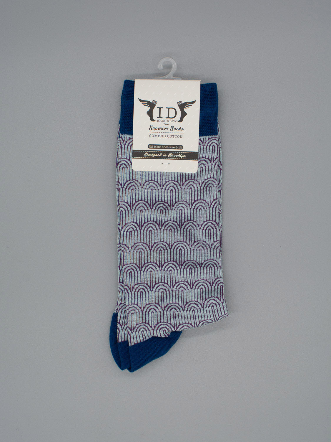 Waterfall Graphic Socks by ID Menswear feature blue, purple, and white arch patterns with dark blue accents, crafted from high-quality combed cotton. Displayed on gray, label reads ID Signature Socks. Fits mens shoe size 8-12.