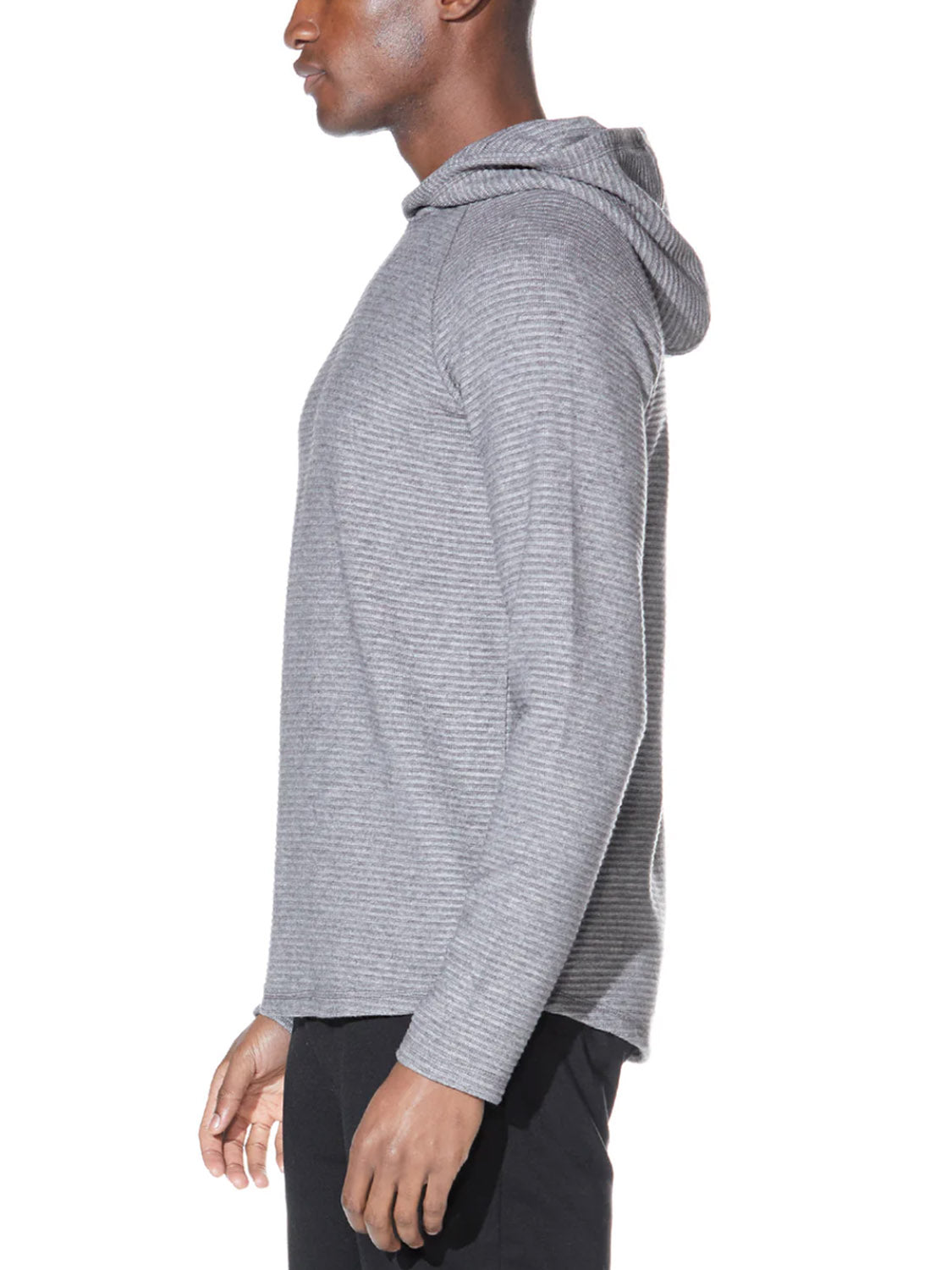 A person in profile against a white background wears the Civil Society Wolfe Waffle Knit Hoodie in light gray with raglan sleeves, paired with black pants.