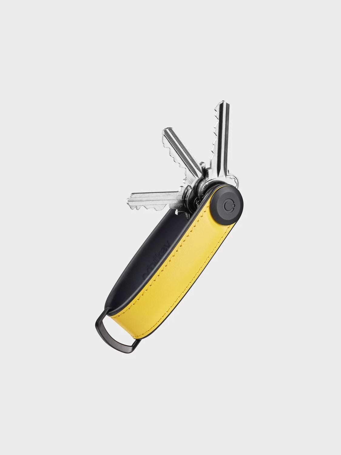 A black and yellow Orbitkeys Key Organizer Hybrid Leather holds several silver keys fanned out, featuring a secure locking mechanism and a metal loop at one end, set against a plain light background.