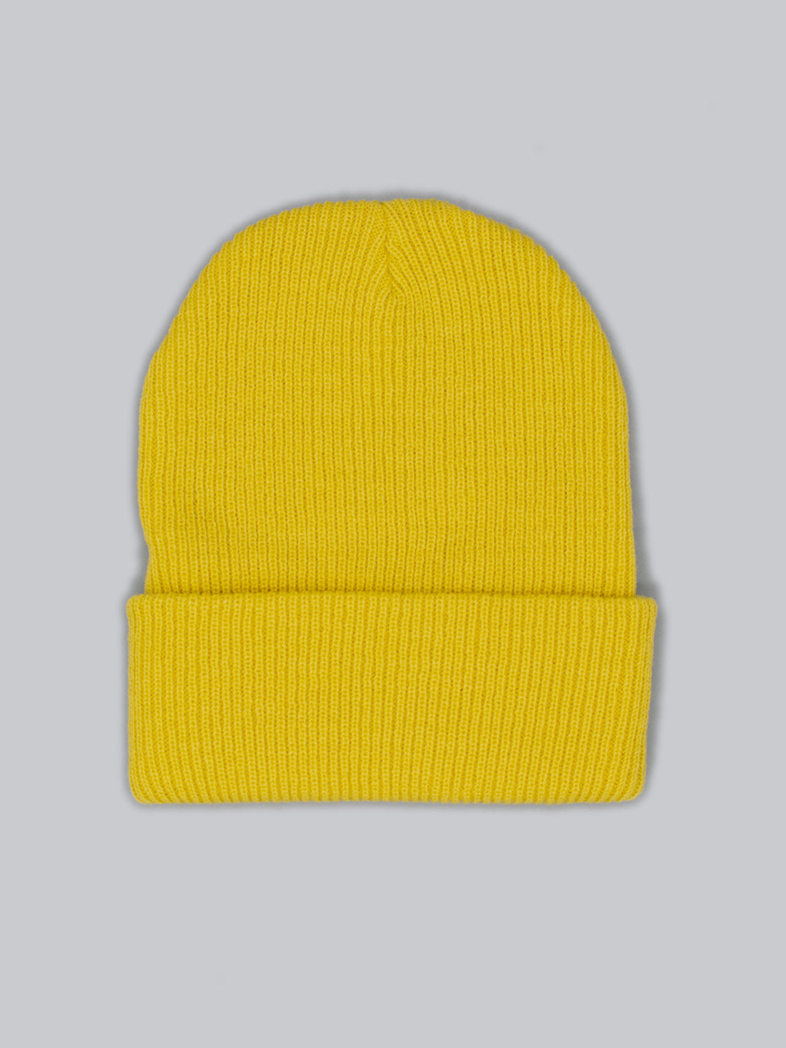 Set against a plain gray background, the Yonker Ribbed Acrylic Beanie from ID Menswear showcases a fisherman style in bright yellow. Its folded brim and rib-knit texture promise coziness and warmth, crafted from soft acrylic, ideal for chilly days.