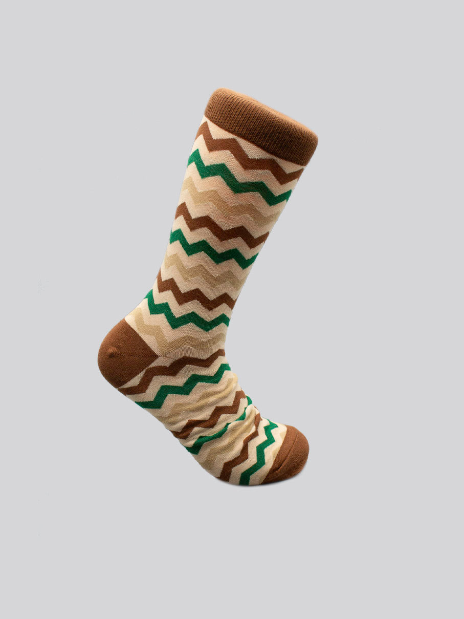 Introducing Zigster Graphic Socks by ID Menswear—a limited edition single sock with brown, beige, and green zigzags on light gray combed cotton, finished with solid brown toe, heel, and cuff.