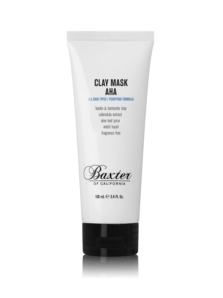 A white tube of Baxter Clay Mask AHA, 100 ml (3.4 fl oz), features black text, a black cap, and a label highlighting key ingredients. This fragrance-free detoxifying facial mask is from Baxter.