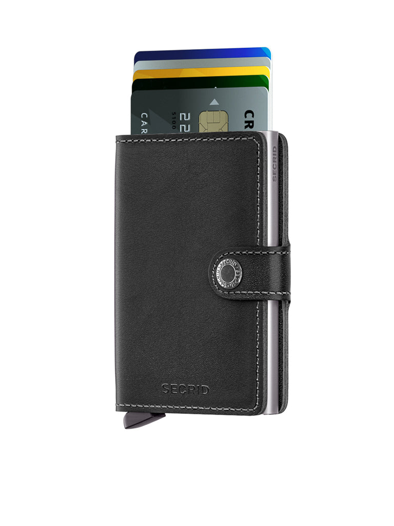 The Secrid Miniwallet Original in black leather, featuring a snap button, is displayed against a white background with several credit cards partially extended from the top of this RFID wallet.
