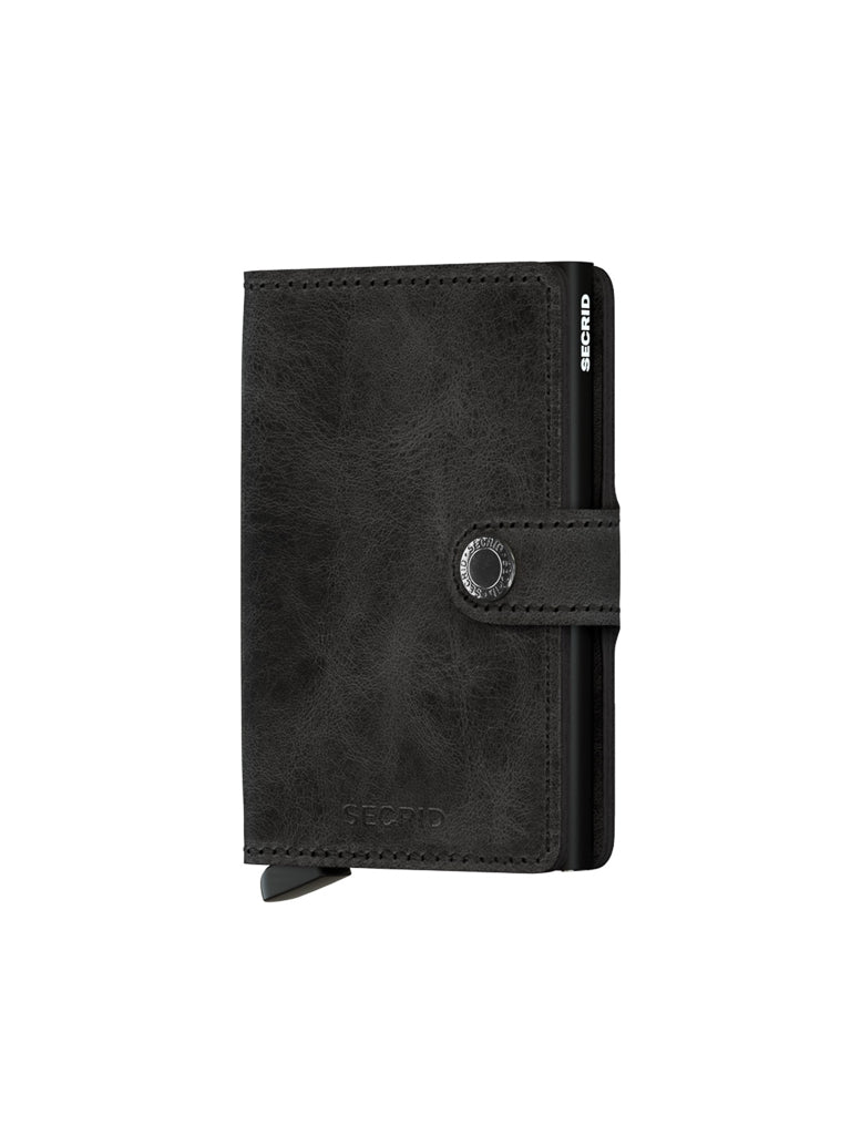 The Secrid Miniwallet Vintage Leather in black features a snap button closure and a visible card-release lever at the bottom, shown on a plain white background.