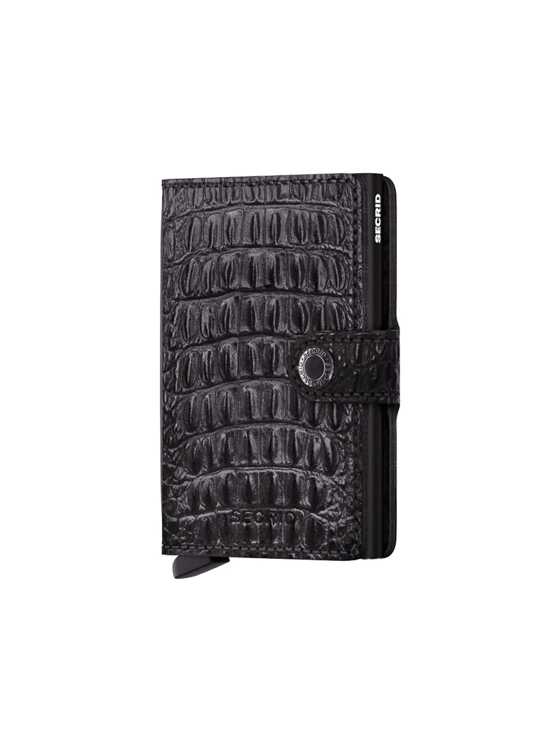 The Secrid Miniwallet Nile is a black RFID wallet crafted from European leather with a crocodile pattern, snap button closure, visible bottom-left card slot, and SECRID branding in white—blending style and security.
